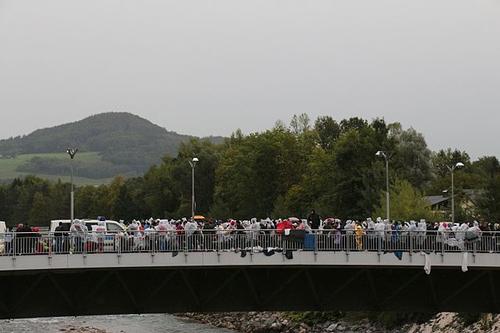 Refugees wait on a bridge between Salzburg in Austria and Freilassing in Bavaria for entry papers 