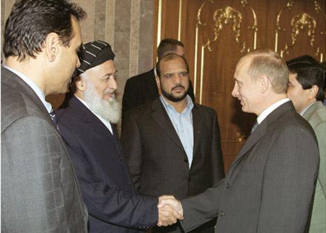 Rabbani shakes hands with Putin