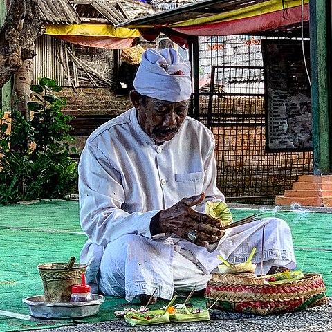 A Balinese Shaman prepares some offering to the gods