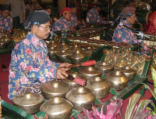 A gamelanplayer playing the bonang, Indonesia