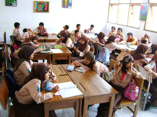  junior high school students wearing pramuka (Indonesian scout) uniform