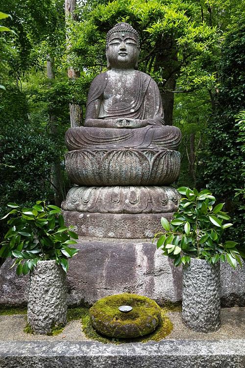 Stone Buddha statue at Zen Buddhist temple in Kyoto Japan